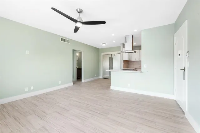 a view of a kitchen with a sink and a refrigerator