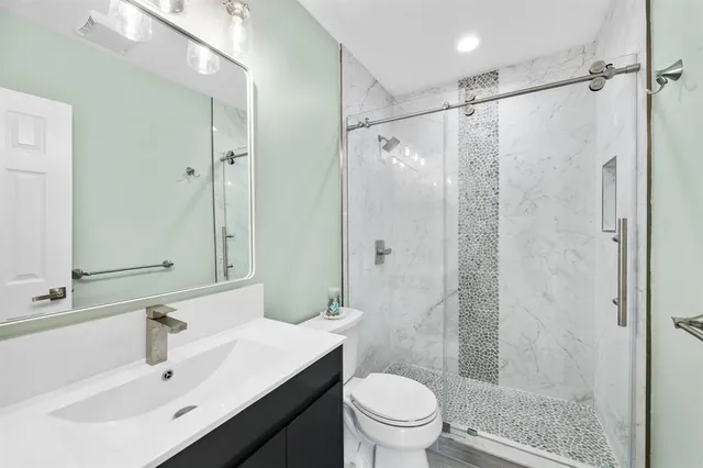 a bathroom with a sink toilet and shower