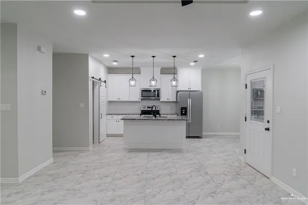 a kitchen with stainless steel appliances refrigerator sink and cabinets