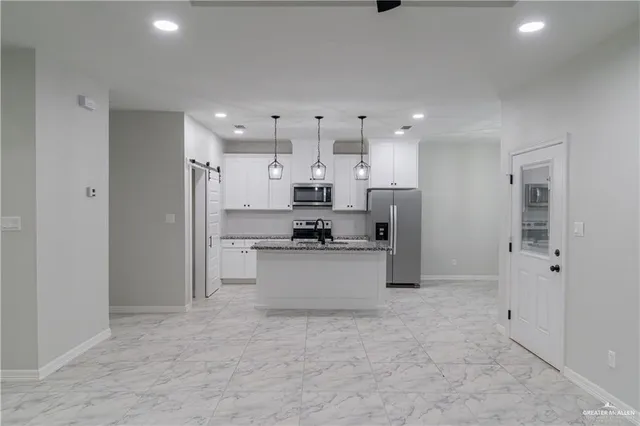 a kitchen with stainless steel appliances refrigerator sink and cabinets