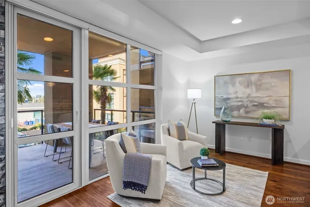a living room with furniture a table and a large window