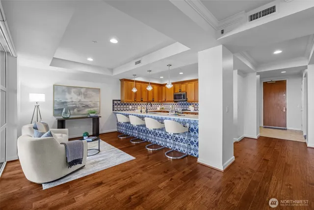 a living room with furniture and a wooden floor