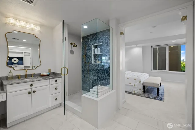 a spacious bathroom with a granite countertop sink mirror and bathtub