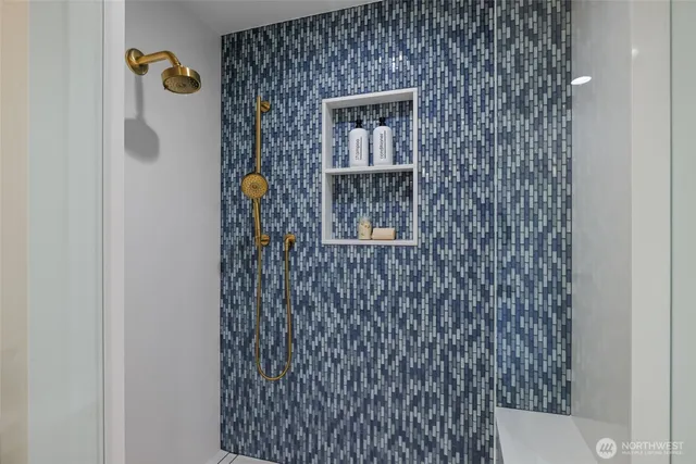 a bathroom with a shower and a sink