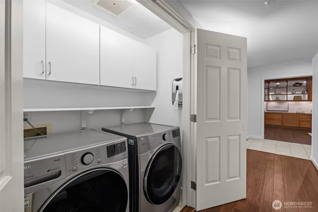a kitchen with counter top space and living room