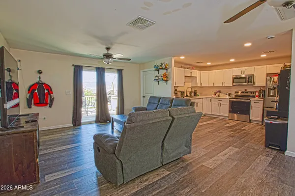 a living room with furniture and a ceiling fan