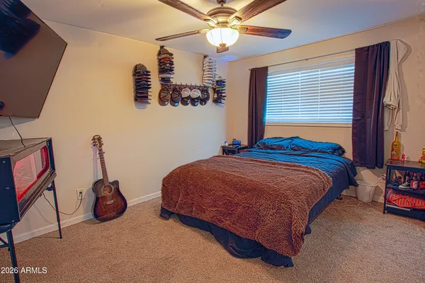 a bedroom with a bed and a chandelier