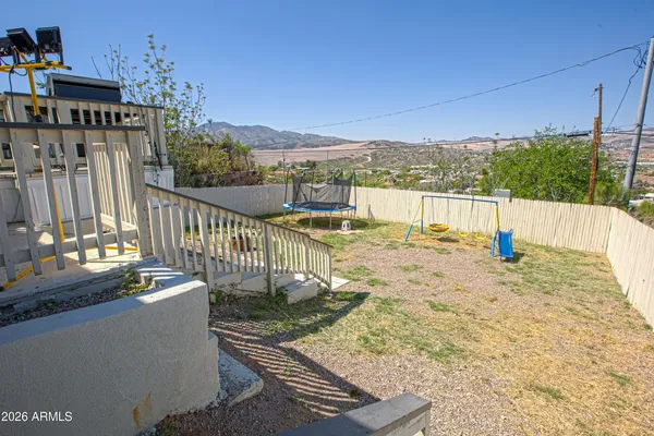 a view of balcony with wooden floor and fence