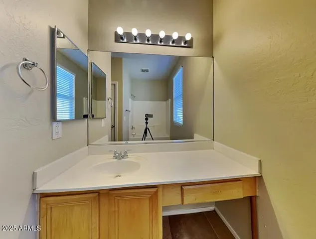a bathroom with a sink and a mirror