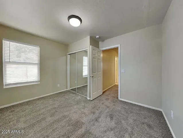 an empty room with a empty space and windows