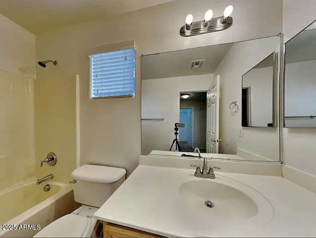 a bathroom with a sink a toilet a mirror and shower