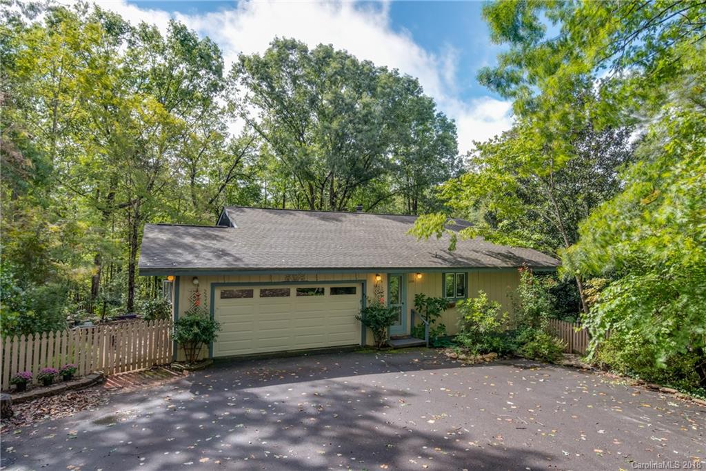 1235 Braewick Road Tryon, NC 28782 - Photo 1 of 22 a view of a house with a yard plants and large tree