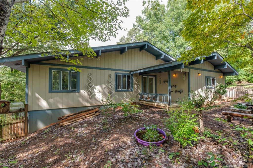 1235 Braewick Road Tryon, NC 28782 - Photo 2 of 22 a front view of a house with garden