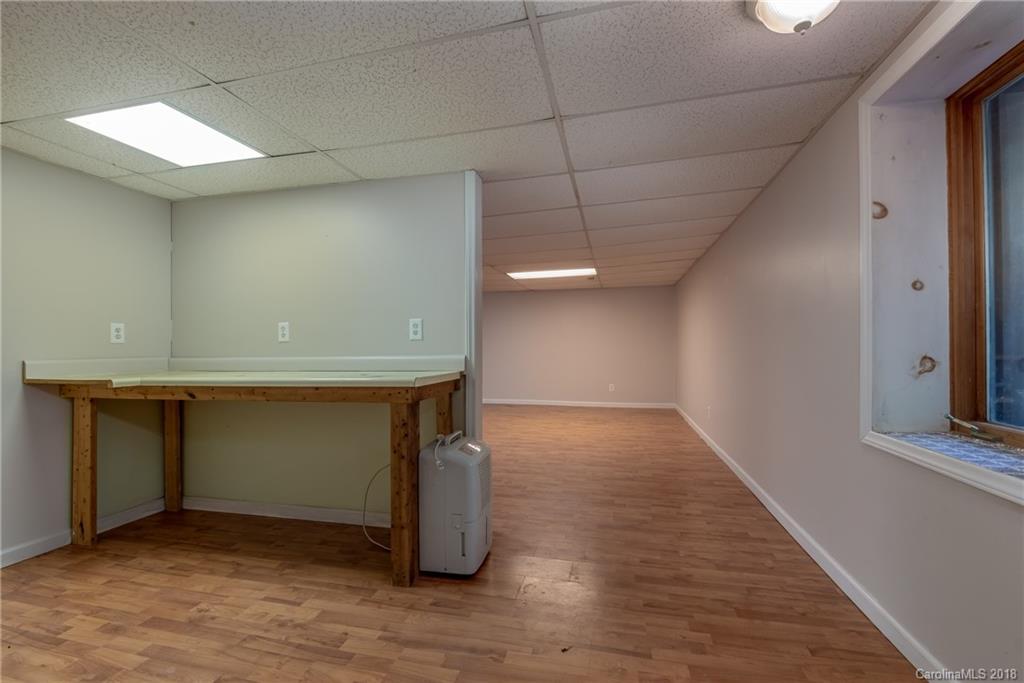 1235 Braewick Road Tryon, NC 28782 - Photo 18 of 22 a view of an empty room with wooden floor