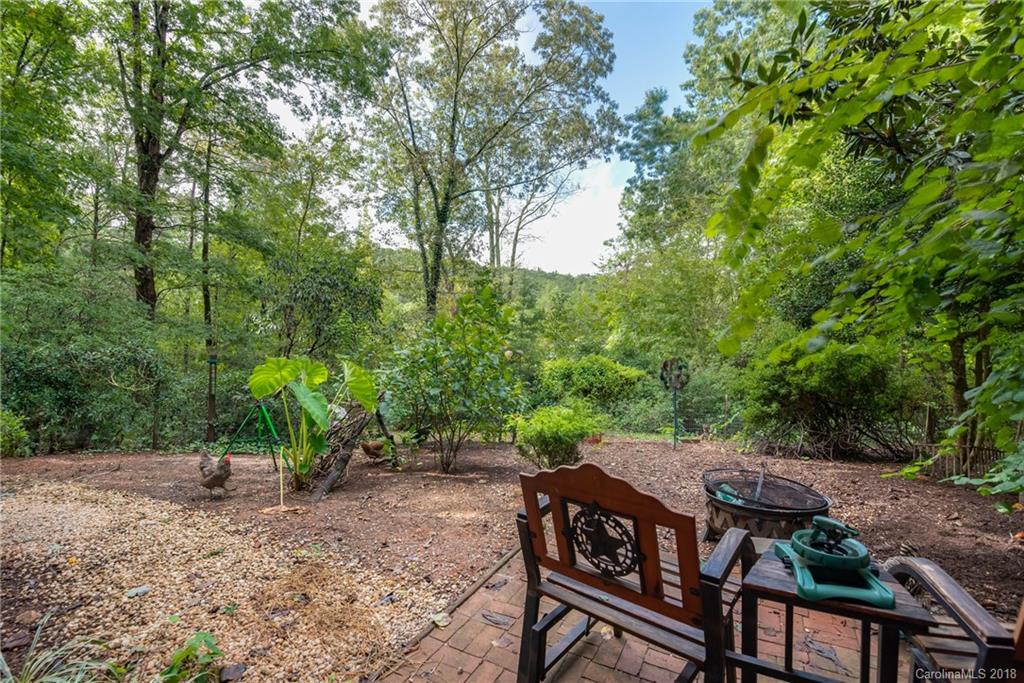 1235 Braewick Road Tryon, NC 28782 - Photo 22 of 22 an aerial view of a wooden table and chairs under an umbrella