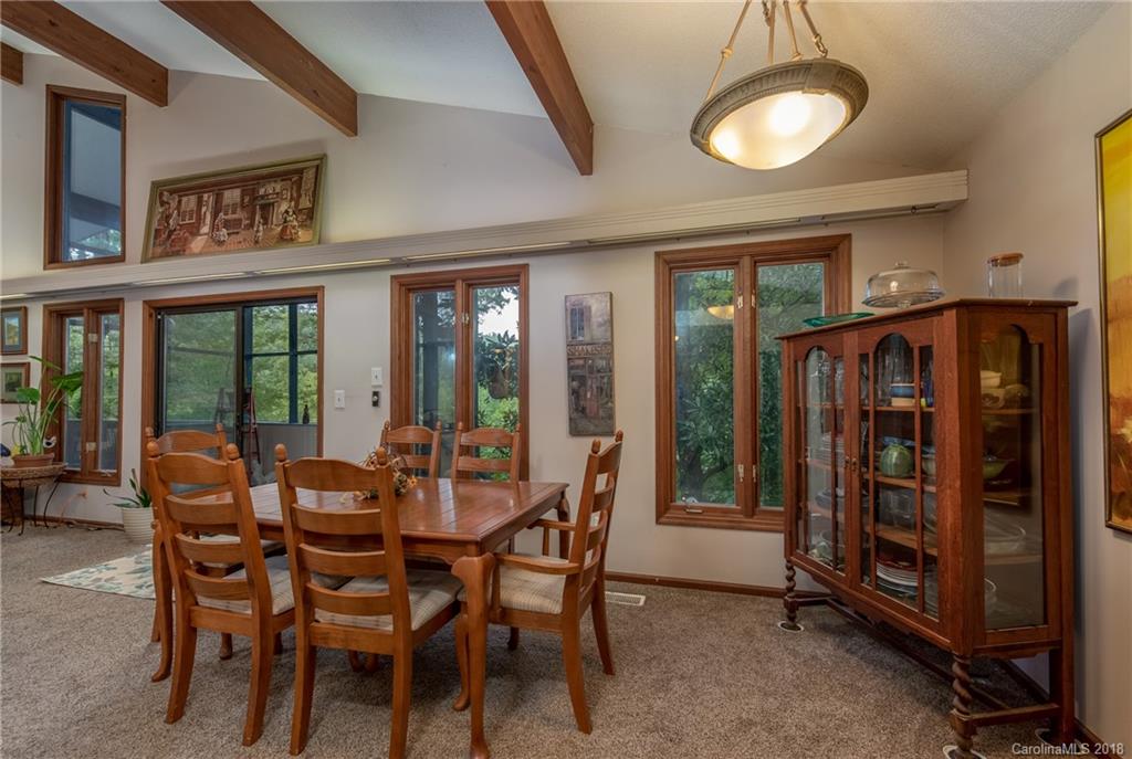 1235 Braewick Road Tryon, NC 28782 - Photo 5 of 22 a view of a dining room with furniture window and outside view