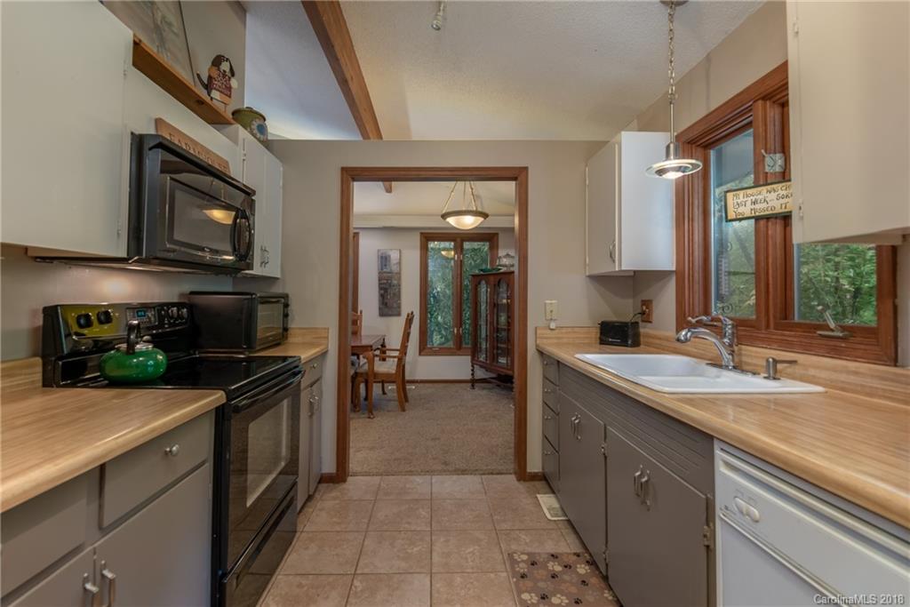 1235 Braewick Road Tryon, NC 28782 - Photo 7 of 22 a kitchen with a sink and stainless steel appliances
