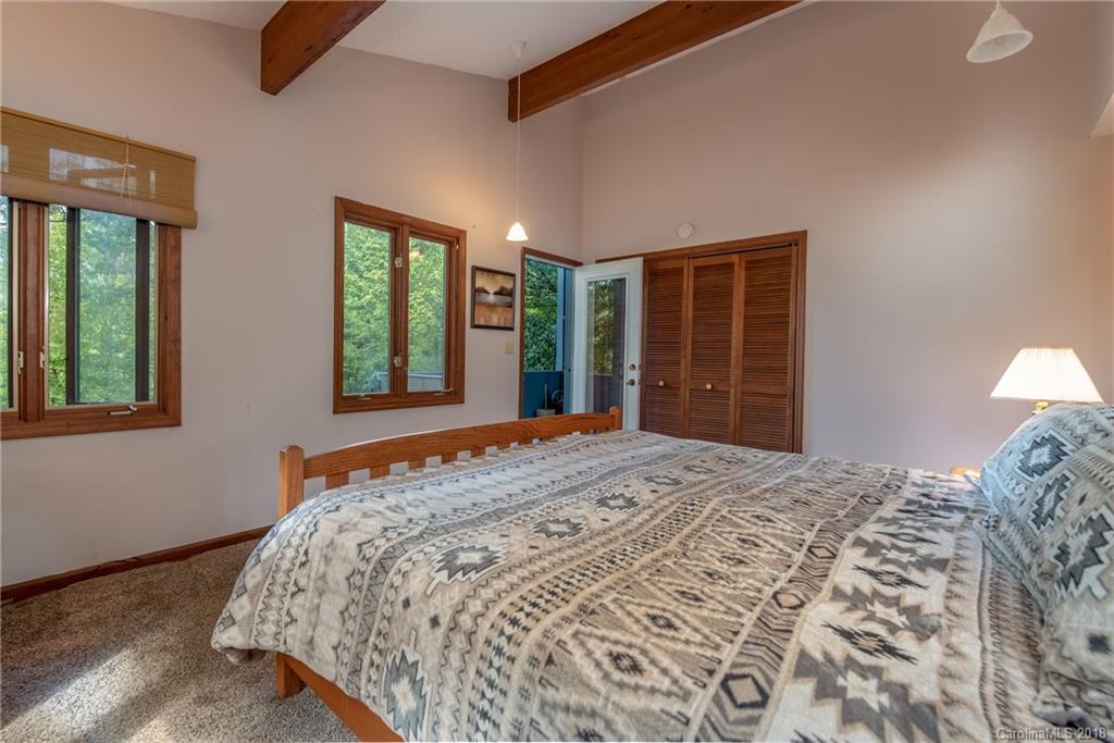 1235 Braewick Road Tryon, NC 28782 - Photo 9 of 22 a bedroom with a large bed and a window
