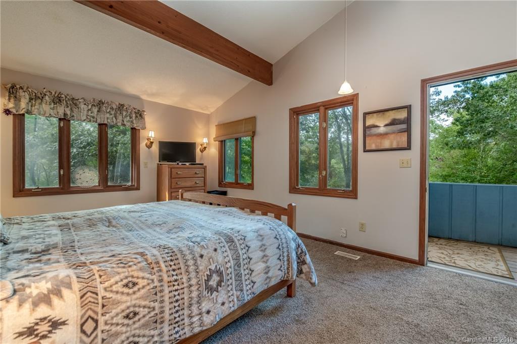 1235 Braewick Road Tryon, NC 28782 - Photo 10 of 22 a bedroom with a large bed and a large window