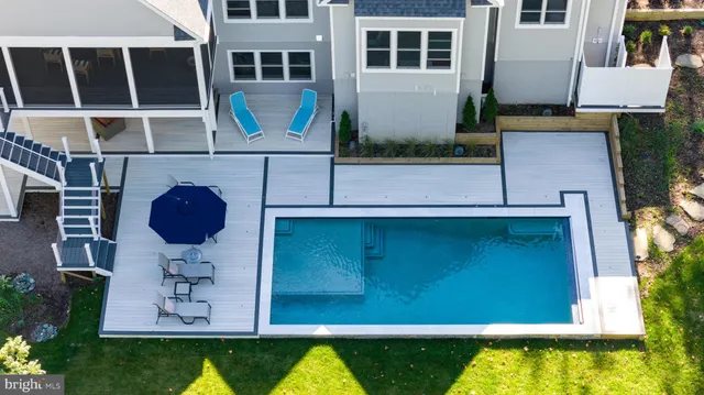 a view of swimming pool with two chairs