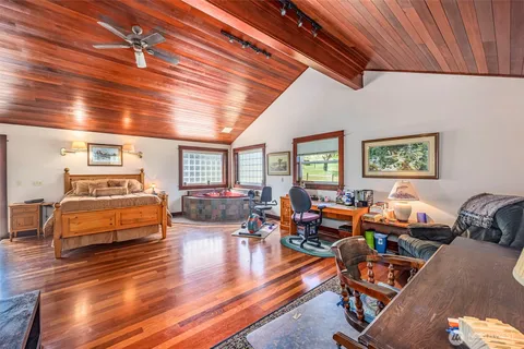 a living room with furniture kitchen view and a large window