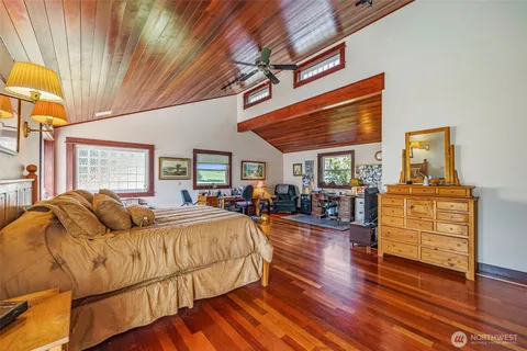 a bedroom with furniture and wooden floor