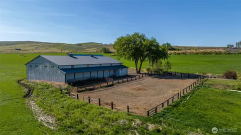 an aerial view of a house having yard and swimming pool