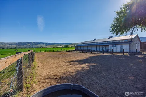 a view of a backyard with wooden fence