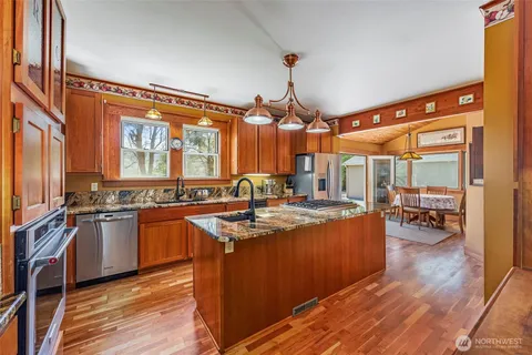 a kitchen with stainless steel appliances granite countertop a stove and a refrigerator