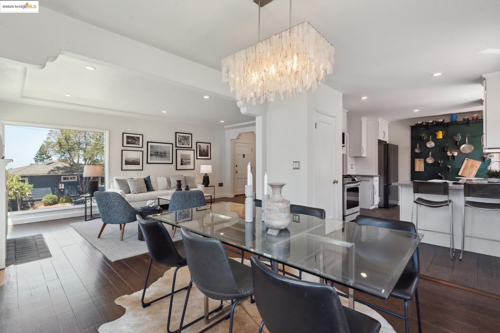 Undisclosed Address Oakland, CA 94619 - Photo 13 of 60 a dining room with furniture a chandelier and wooden floor