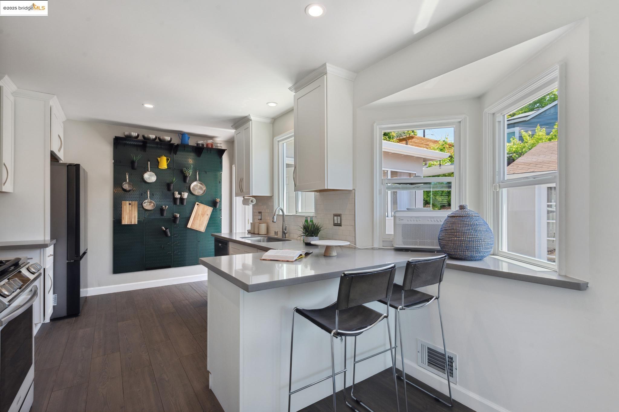 Undisclosed Address Oakland, CA 94619 - Photo 15 of 60 a kitchen with stainless steel appliances granite countertop a sink and a refrigerator