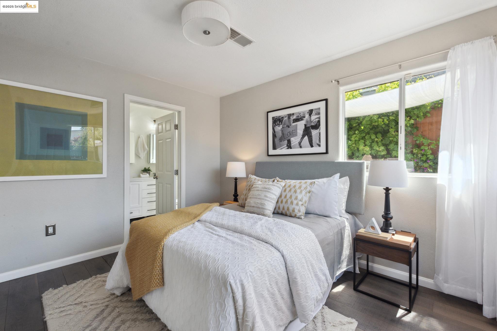 Undisclosed Address Oakland, CA 94619 - Photo 19 of 60 a bedroom with a bed and a painting on the wall