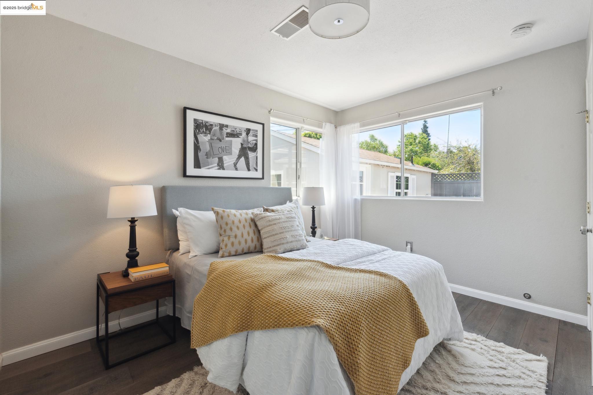 Undisclosed Address Oakland, CA 94619 - Photo 20 of 60 a bed room with a bed and a painting on the wall