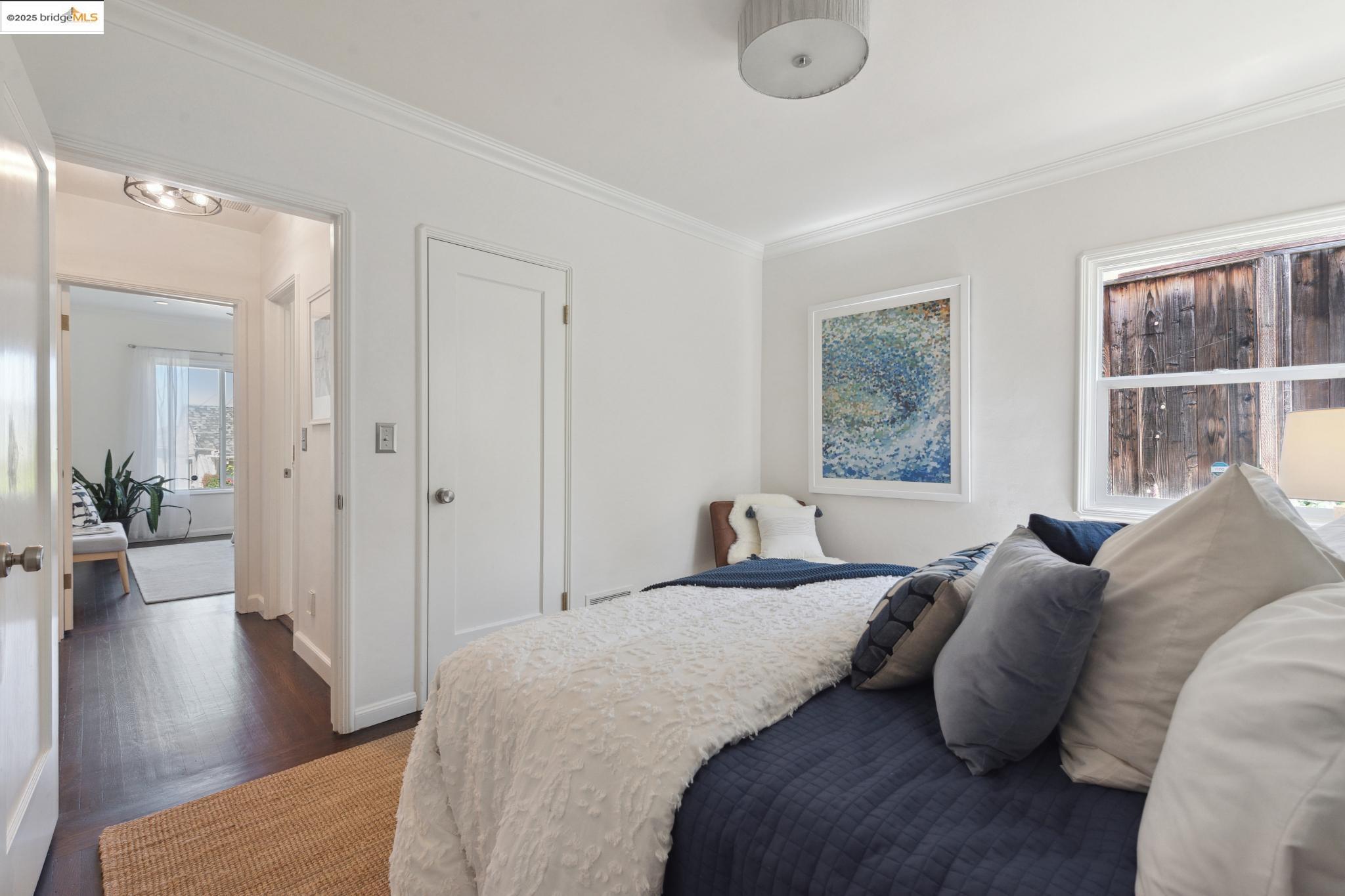 Undisclosed Address Oakland, CA 94619 - Photo 29 of 60 a bedroom with a bed and wooden floor