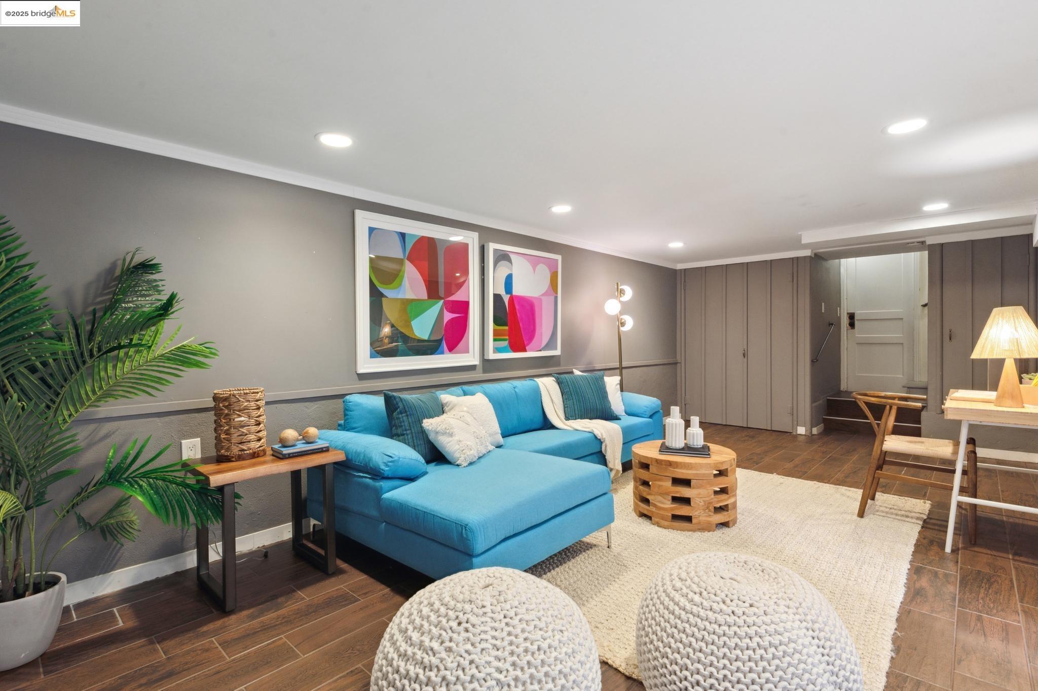 Undisclosed Address Oakland, CA 94619 - Photo 30 of 60 a living room with furniture and a painting on the wall