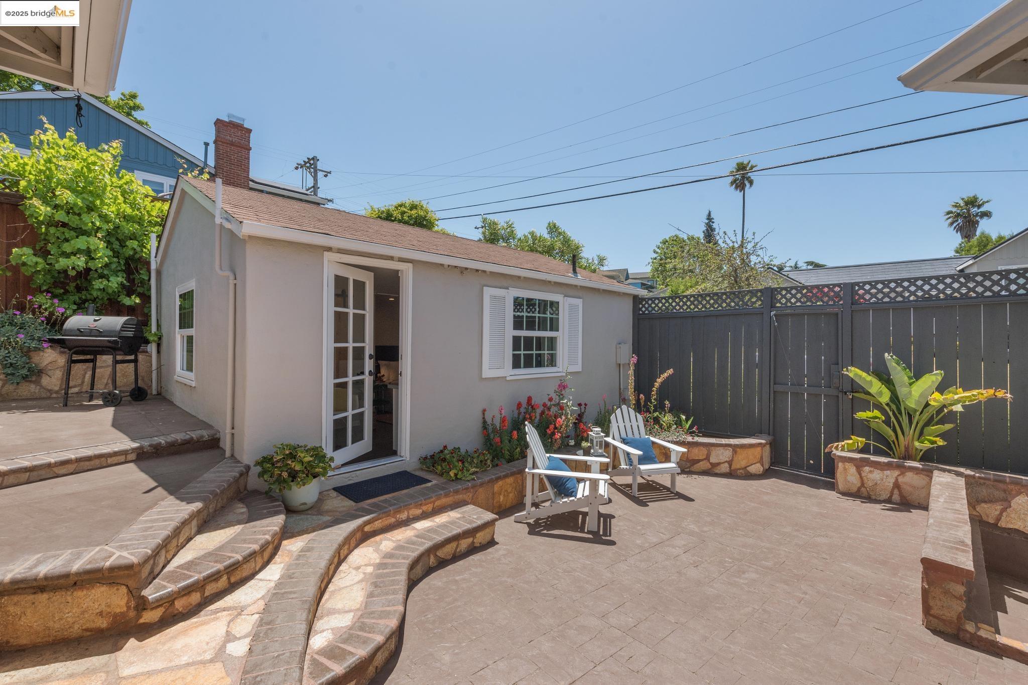 Undisclosed Address Oakland, CA 94619 - Photo 36 of 60 a view of a patio with table and chairs potted plants with wooden fence