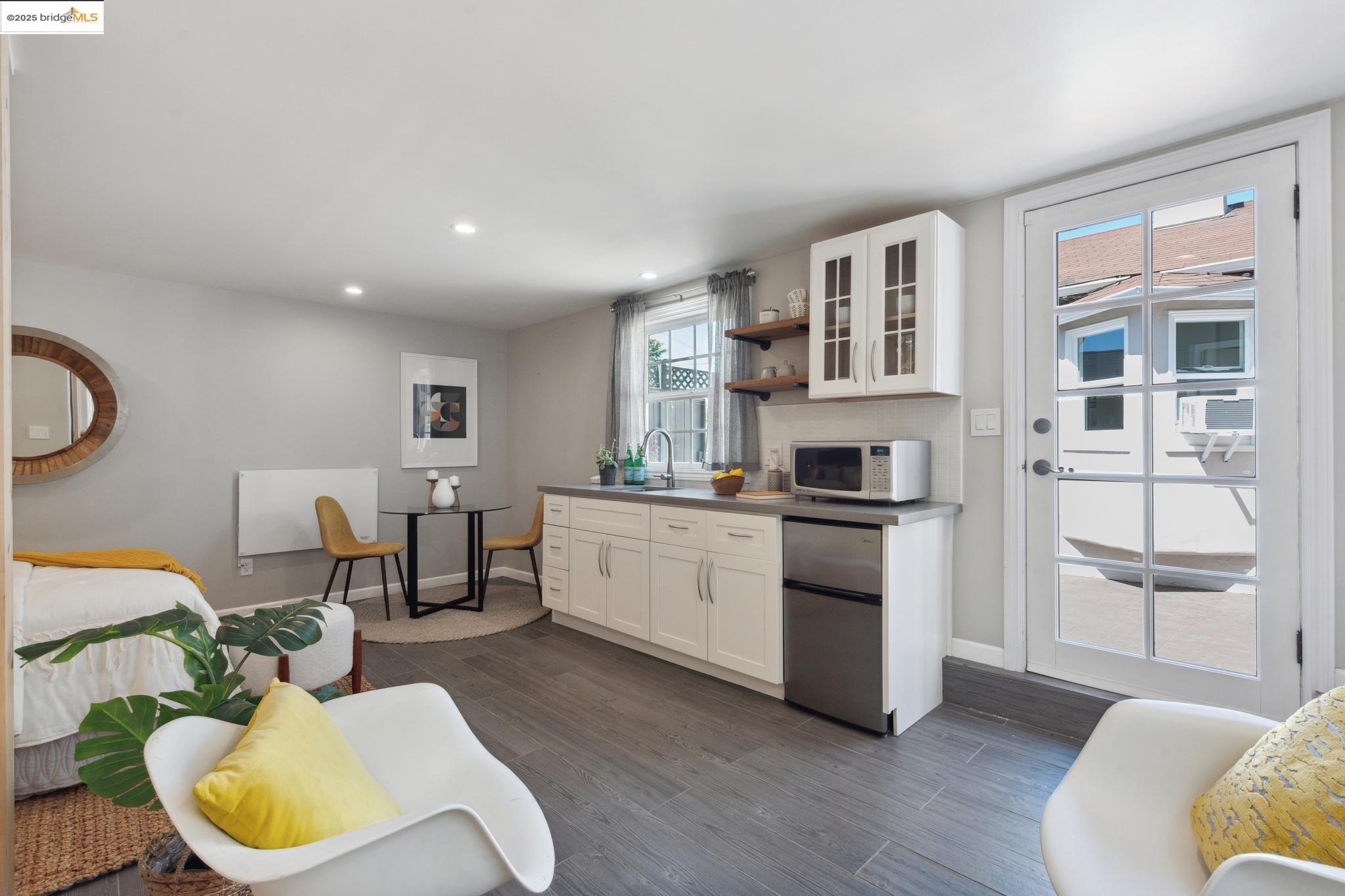 Undisclosed Address Oakland, CA 94619 - Photo 38 of 60 a living room with stainless steel appliances furniture and a kitchen view