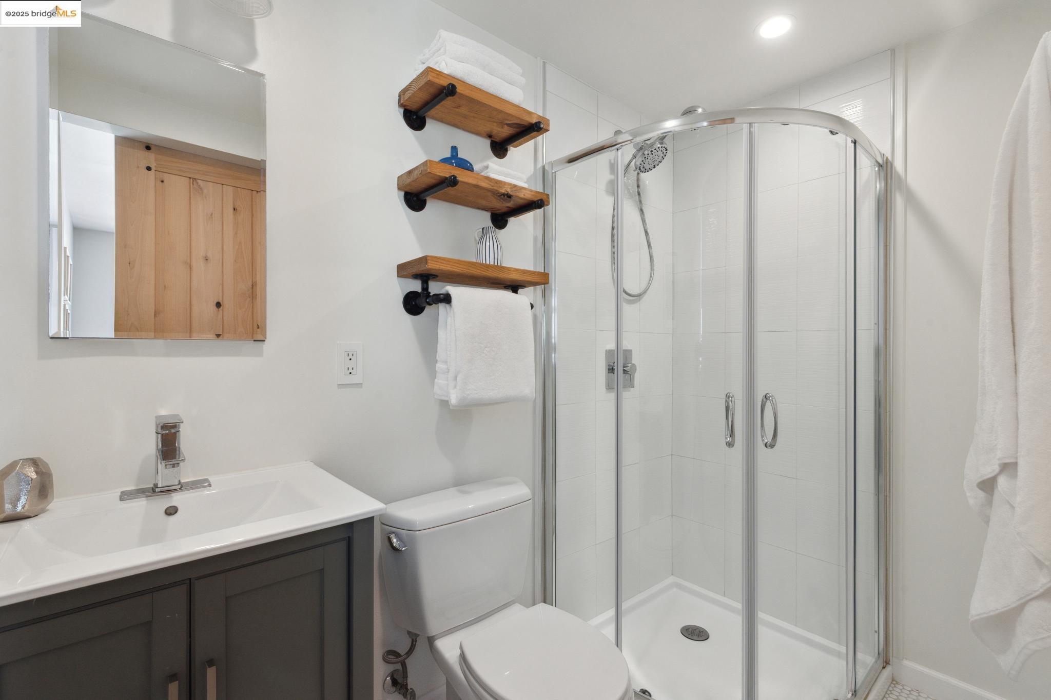 Undisclosed Address Oakland, CA 94619 - Photo 42 of 60 a bathroom with a shower sink mirror and toilet