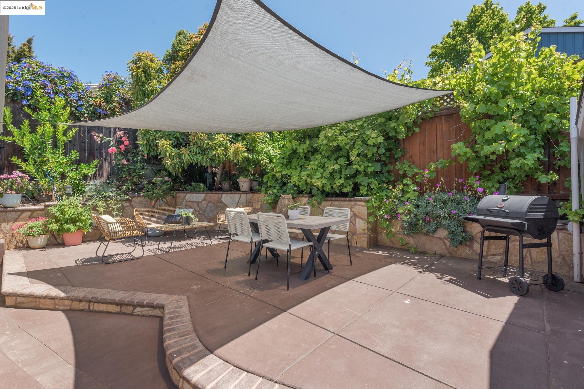 Undisclosed Address Oakland, CA 94619 - Photo 44 of 60 a view of a patio with table and chairs under an umbrella