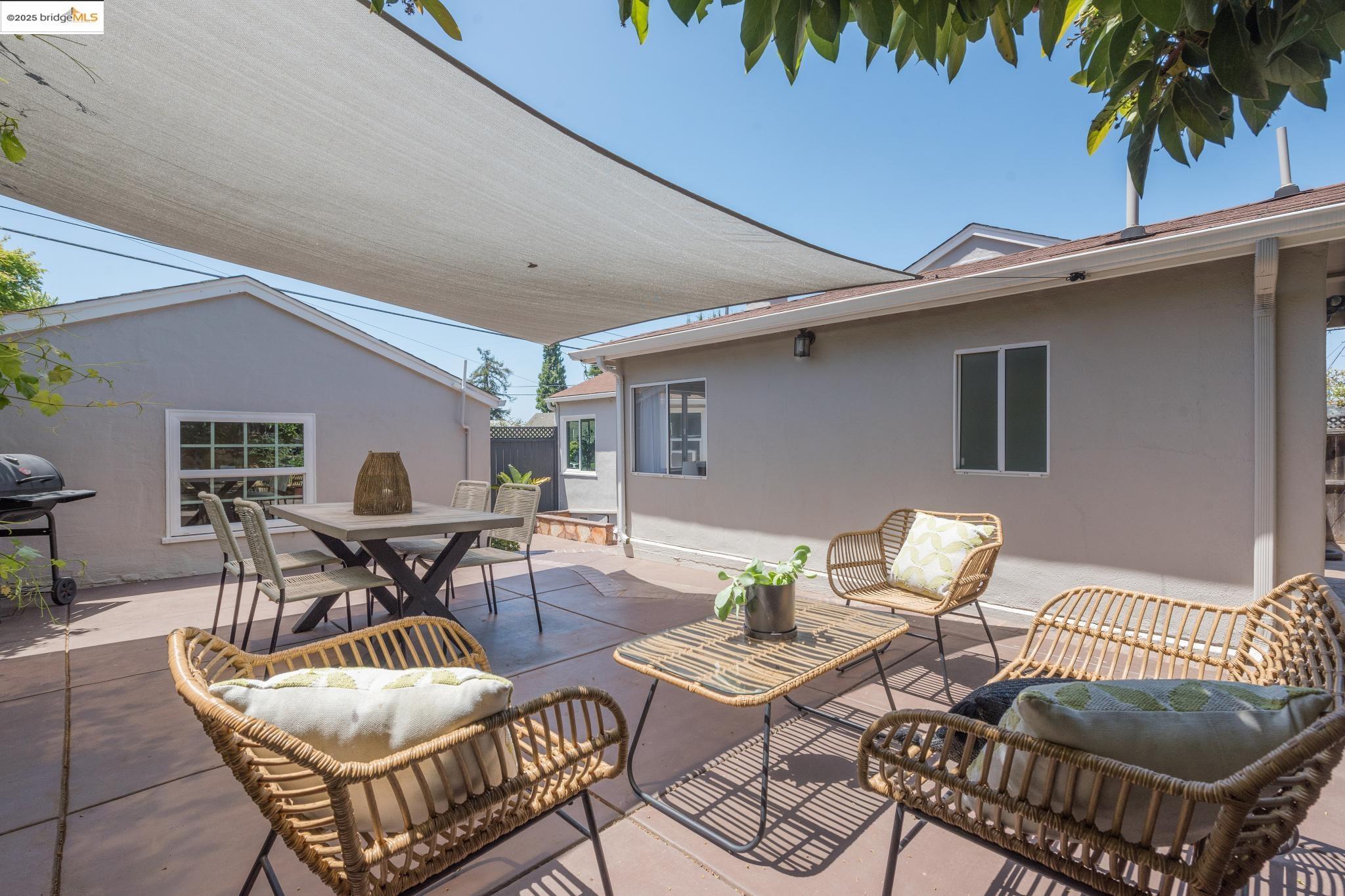 Undisclosed Address Oakland, CA 94619 - Photo 48 of 60 a patio with a table and chairs and potted plants