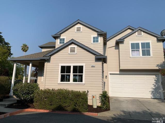 2415 B Guerneville Road Santa Rosa, CA 95403 - Photo 1 of 1 a front view of a house with a yard and garage
