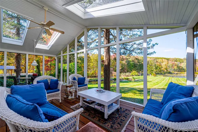 a living room with furniture and a floor to ceiling window