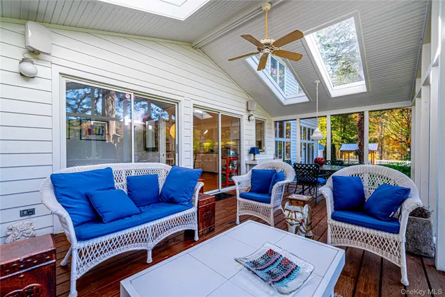 a living room with furniture a fireplace and a large window