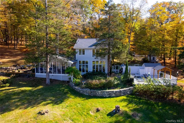 a view of a house with swimming pool and a yard