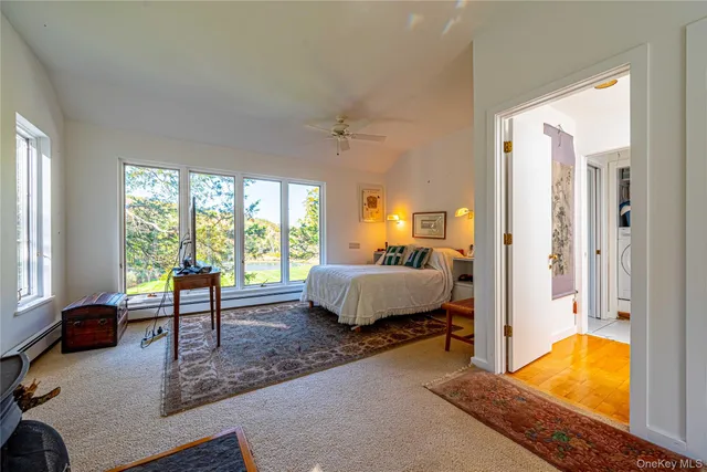 a bedroom with a bed and large window