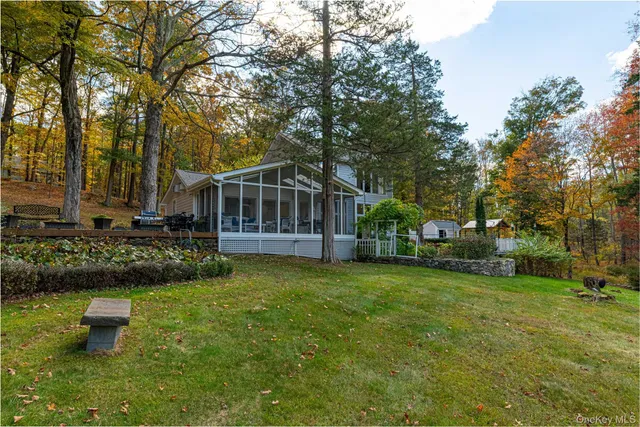 a view of a house with a yard and sitting area
