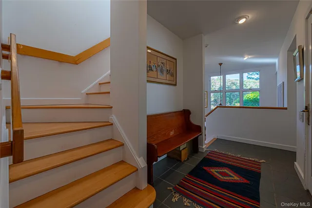 a living room with furniture a rug and a window