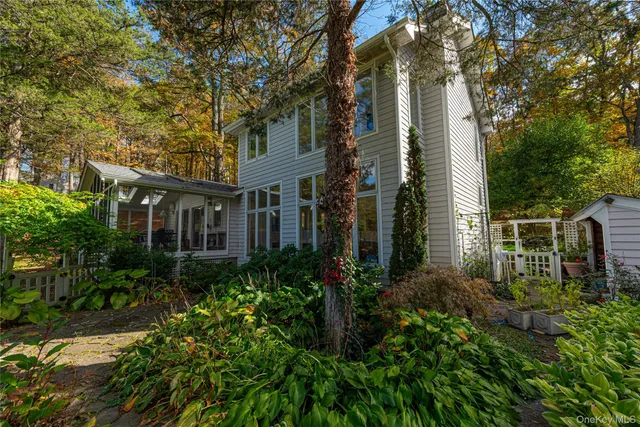 a view of a house with brick walls and plants