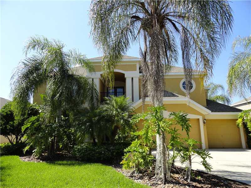 18914 Chaville Road Lutz, FL 33558 - Photo 1 of 1 a front view of multi story residential apartment building with yard and green space
