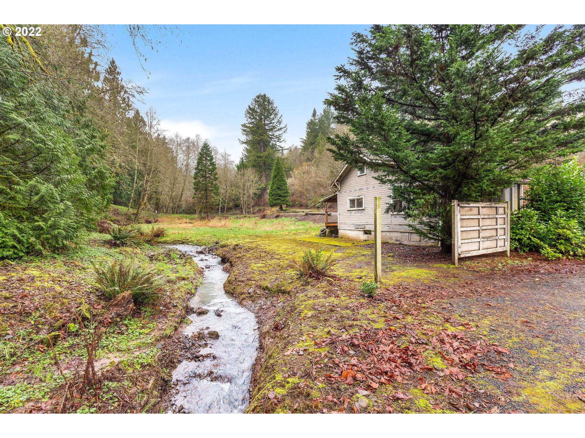 15055 Northwest Cornelius Pass Road Portland, OR 97231 - Photo 1 of 13 a backyard of a house with a yard and outdoor seating